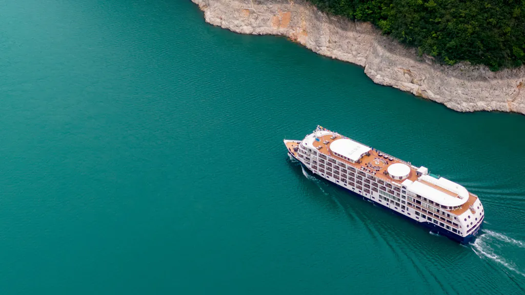 Aerial view of the Yangzi Explorer luxury cruise ship sailing through the dramatic landscapes of the Three Gorges in China
